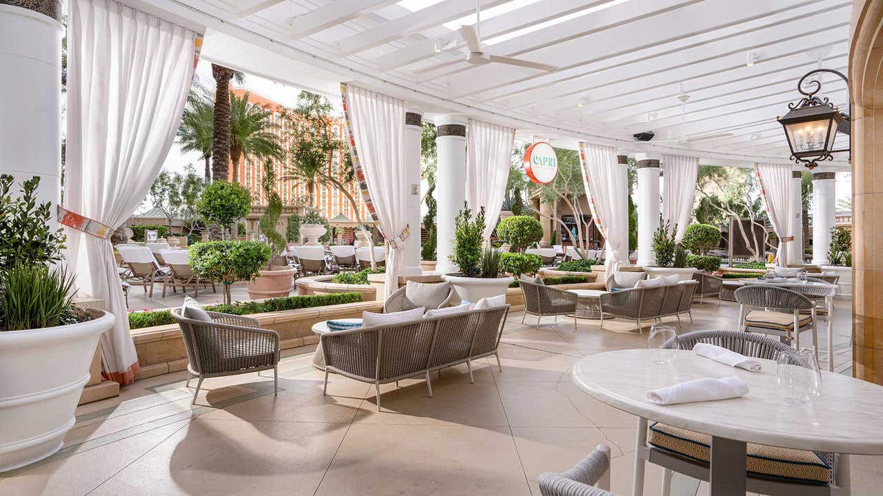 A patio dining area with tables and couches.