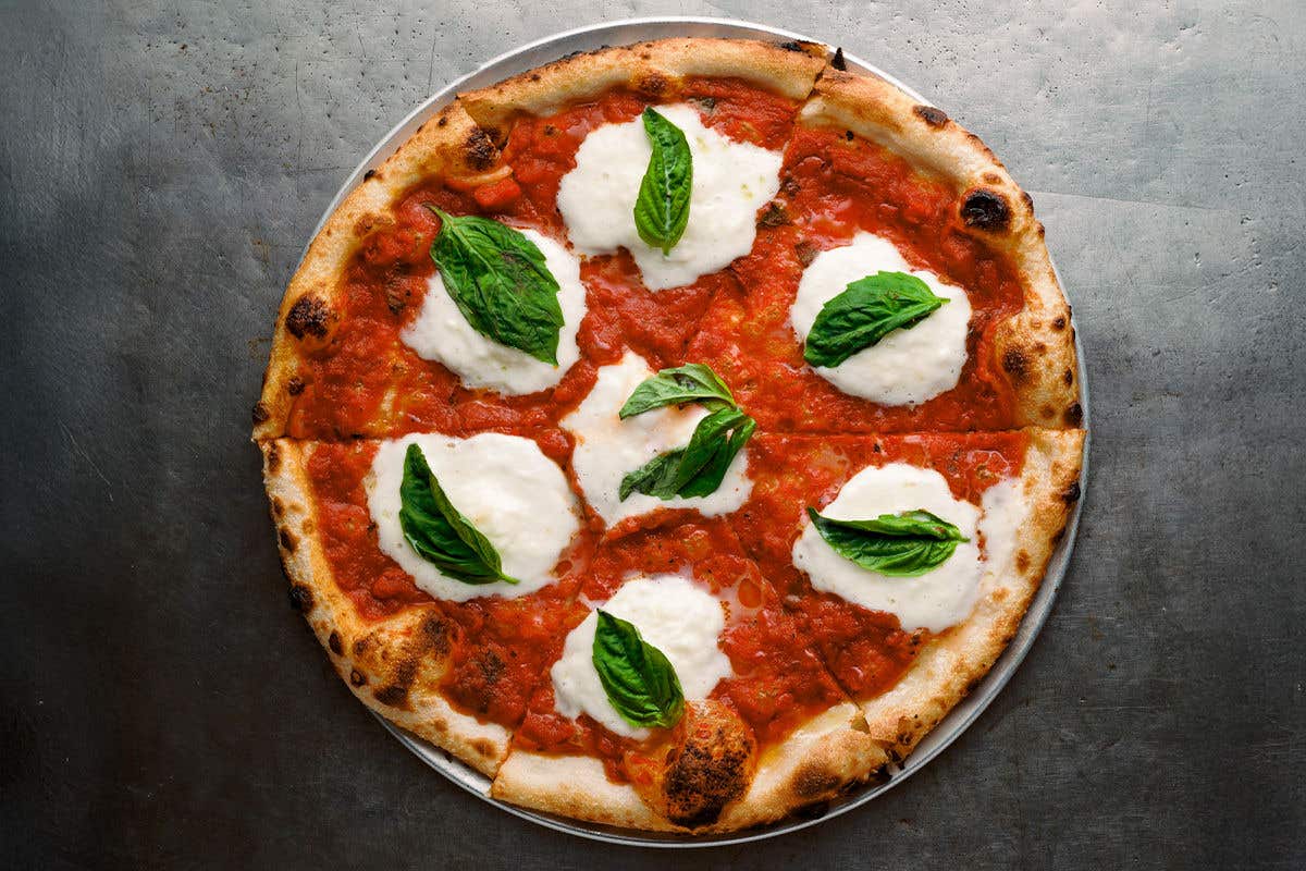 Pizza with red sauce, mozzarella cheese and basil. 